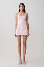 Woman wearing a pink satin mini dress.
